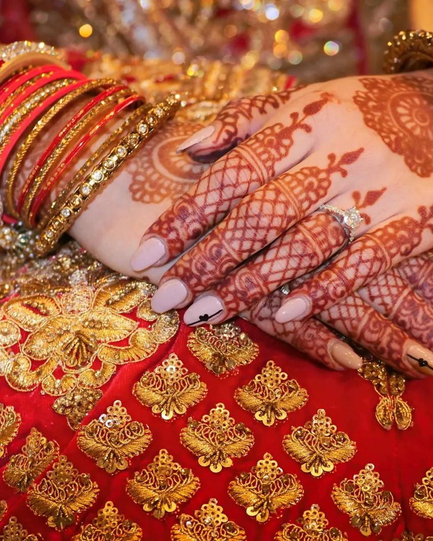 Bridal mehndi with red and gold bangles